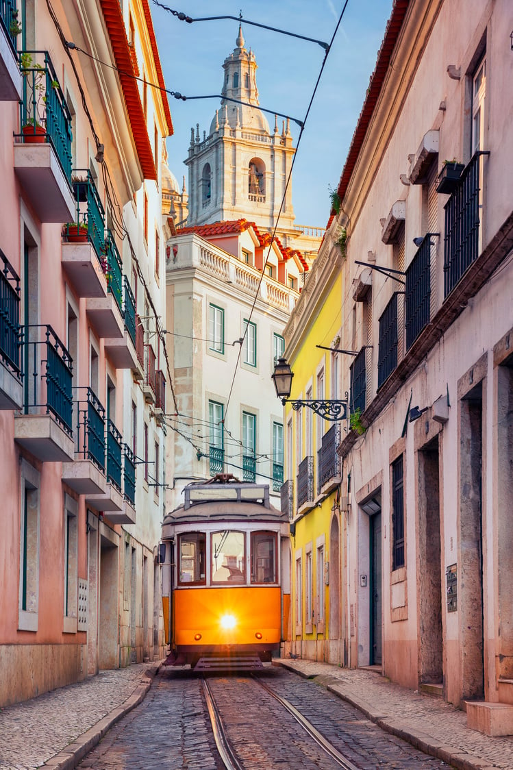 an orange trolley on a narrow cobblestone street in lisbon, portugal.

Portugal Trip; Travel Planner; 3Day Trip Plan; Photography